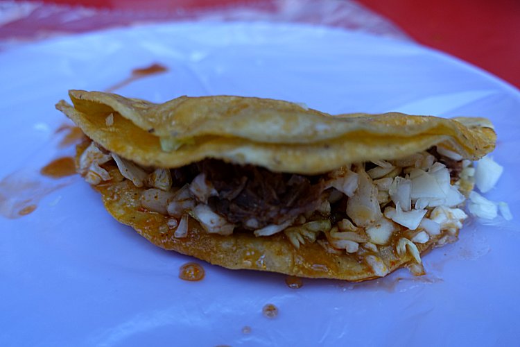 A tasty-looking taco dorado. 'Dorado', literally 'golden', here indicates that the taco has been fried.