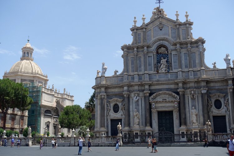 (A) CATANIA: The building on the left is an abbey, and the one on the right is Catania Cathedral. Both are dedicated to St Agatha of Sicily.