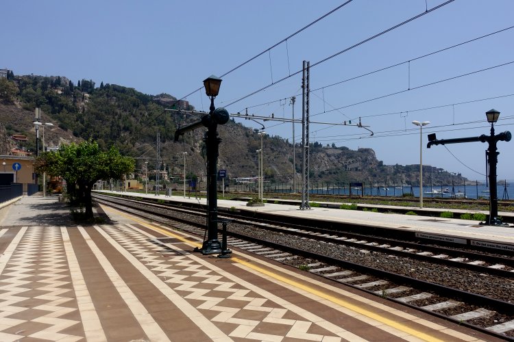 (C) TAORMINA: We were greeted by striking paving and two relics of the steam age on arrival at Taormina Giardini station.