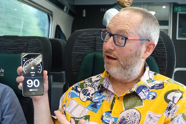 THE DINNER TRAIN: Bruce demonstrates the speedometer function on his seatmate's phone. Nice shirt!